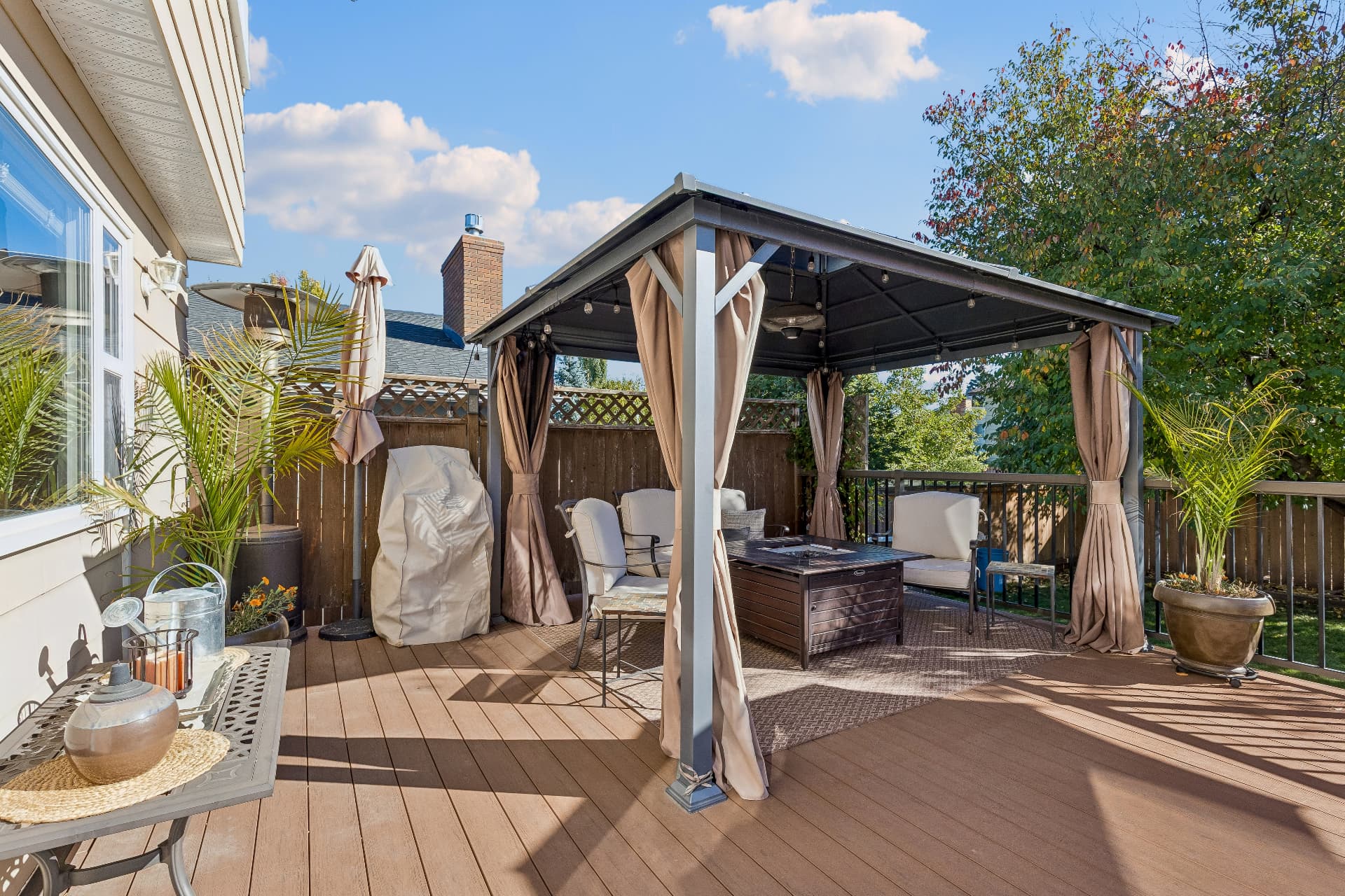 Deck gazebo with fire table and seating