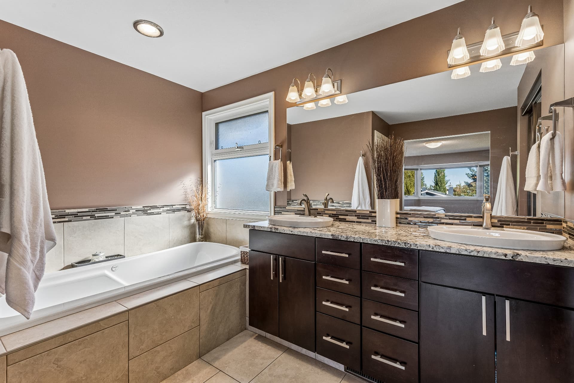Renovated primary ensuite with dual sinks and oversized soaker tub